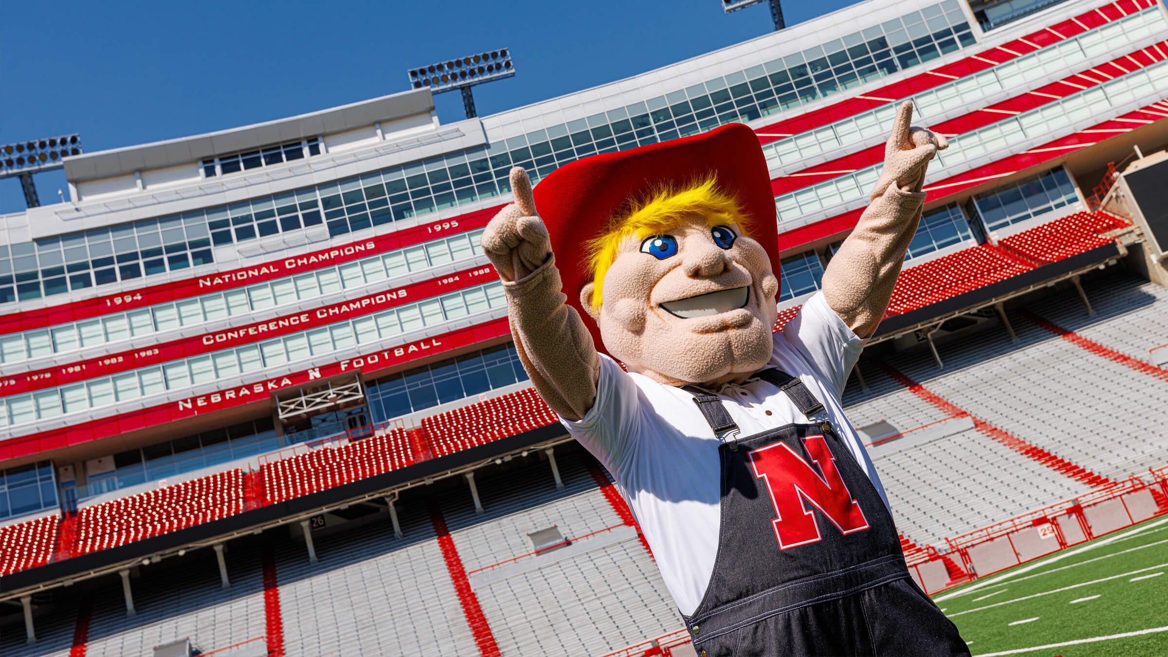 herbie husker posing in memorial stadium