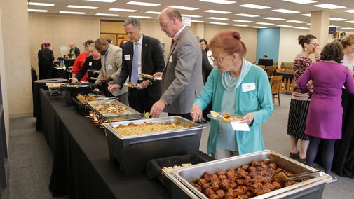 People going through an appetizer line
